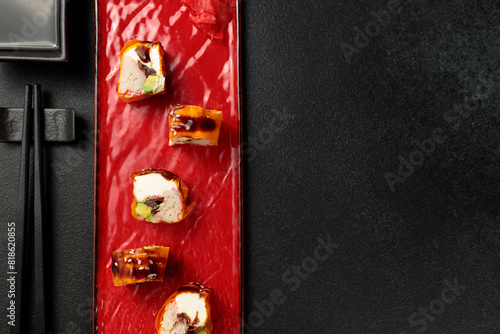 Japanese food: sushi, Mami roll with snow crab. Black background photo