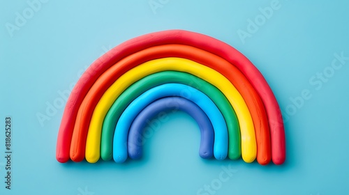 Colorful rainbow of plasticine on blue background