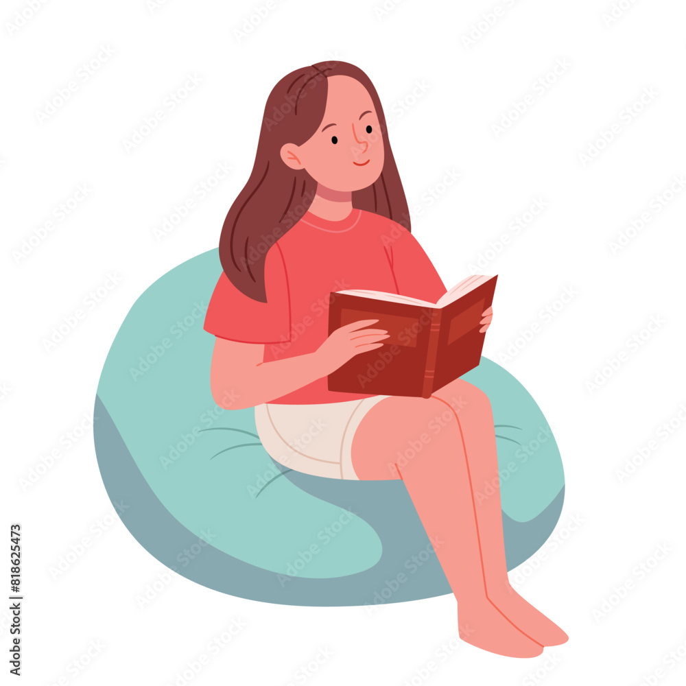 A girl is sitting in a bag chair barefoot with a book. Office, coworking.Working online. Online education. A girl is sitting in a bag chair barefoot with a book. Office, coworking.Working online. Online education.