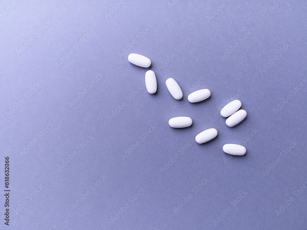 Amino acids tablets. Nutrition for bodybuilding. Fitness supplements on bright paper background. Soft focus. Top view. Copy space. Amino acids tablets. Nutrition for bodybuilding. Fitness supplements on bright paper background. Soft focus. Top view. Copy space.