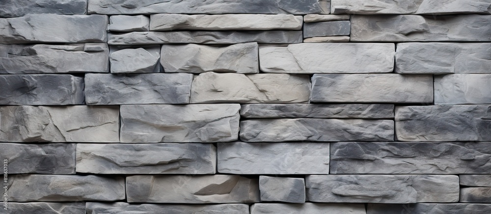 A textured uneven gray stone wall serves as the backdrop for a simple rock blocks background The image contains copy space A textured uneven gray stone wall serves as the backdrop for a simple rock blocks background The image contains copy space