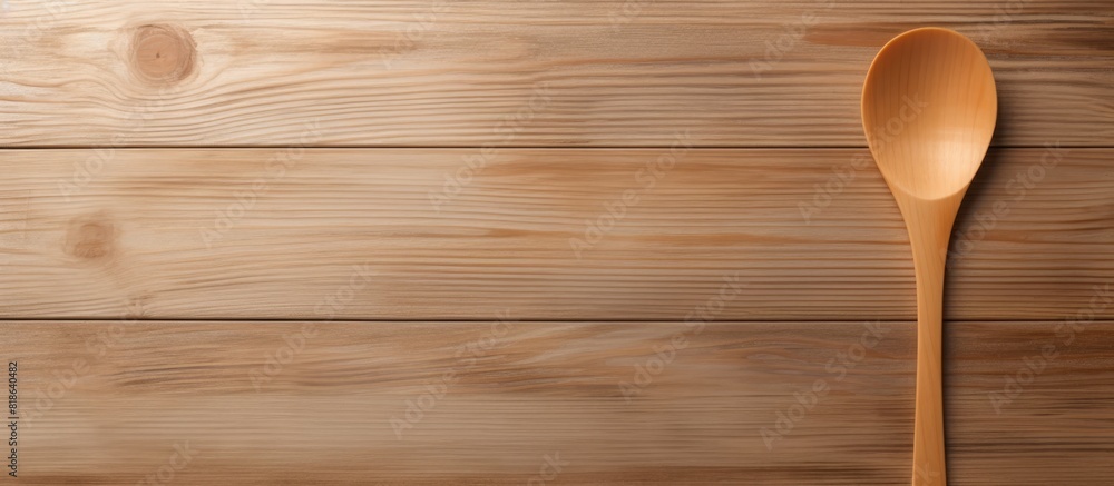 A wooden spoon is seen from above on a wooden table providing an area of empty space in the image. Creative banner. Copyspace image A wooden spoon is seen from above on a wooden table providing an area of empty space in the image. Creative banner. Copyspace image