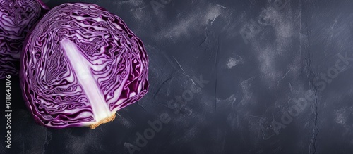 A top down view of red cabbage placed on a grey table with ample copy space available photo