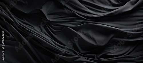 The abstract structure of wrinkles on the fabric is depicted against a simple dark background in this copy space image