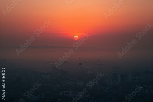 Hazy Skyline at Dusk: A Dramatic Sunset Obscured by Air Pollution