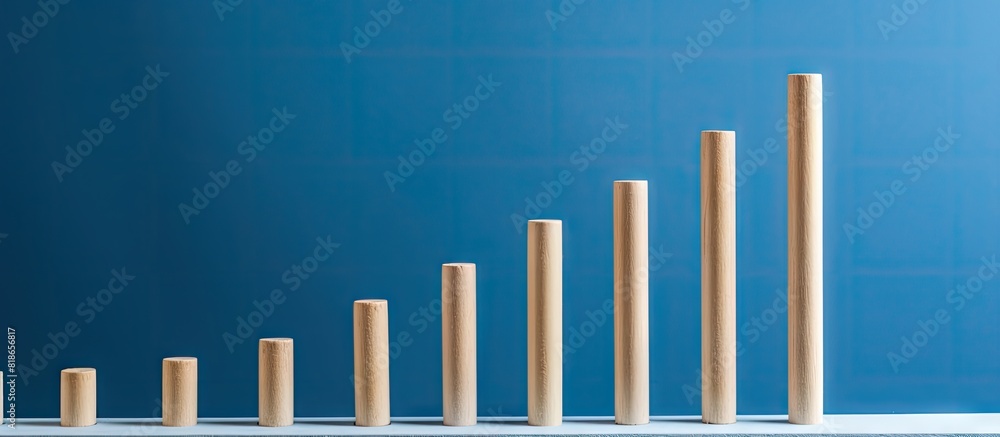 A conceptual image of a staircase with five wooden pegs set against a blue background with ample copy space A conceptual image of a staircase with five wooden pegs set against a blue background with ample copy space