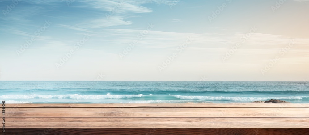 The beachside wooden table creates a peaceful ambiance with the serene sea in the background where people enjoy swimming Ideal copy space image for a creative montage