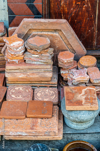 Coasters made of piles of clay with patterns and symbols engraved on them