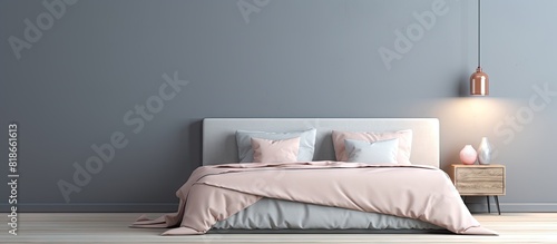 Empty grey wall in a trendy bedroom interior featuring a king size bed with pastel pink beige and blue bedding Copy space image available