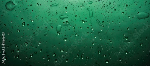 A close up image of water droplets on a green background with abstract texture The green tones create a wet and bubbly look on a plastic PVC or grungy surface The image shows realistic water droplets