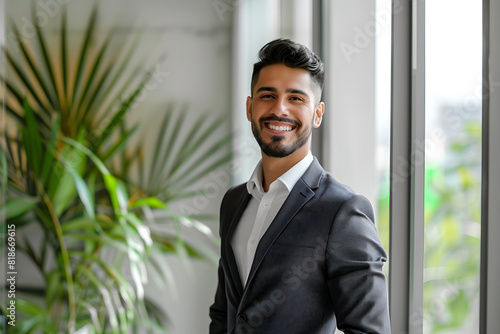 Wallpaper Mural Happy smiling office employee, businessman, manager, in office suit standing in the middle of the office Torontodigital.ca
