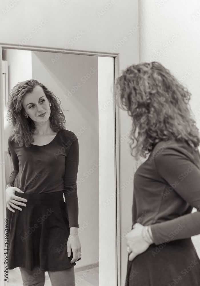 Elegant Woman in Black Dress Admiring Her Reflection in a Full-Length Mirror Elegant Woman in Black Dress Admiring Her Reflection in a Full-Length Mirror