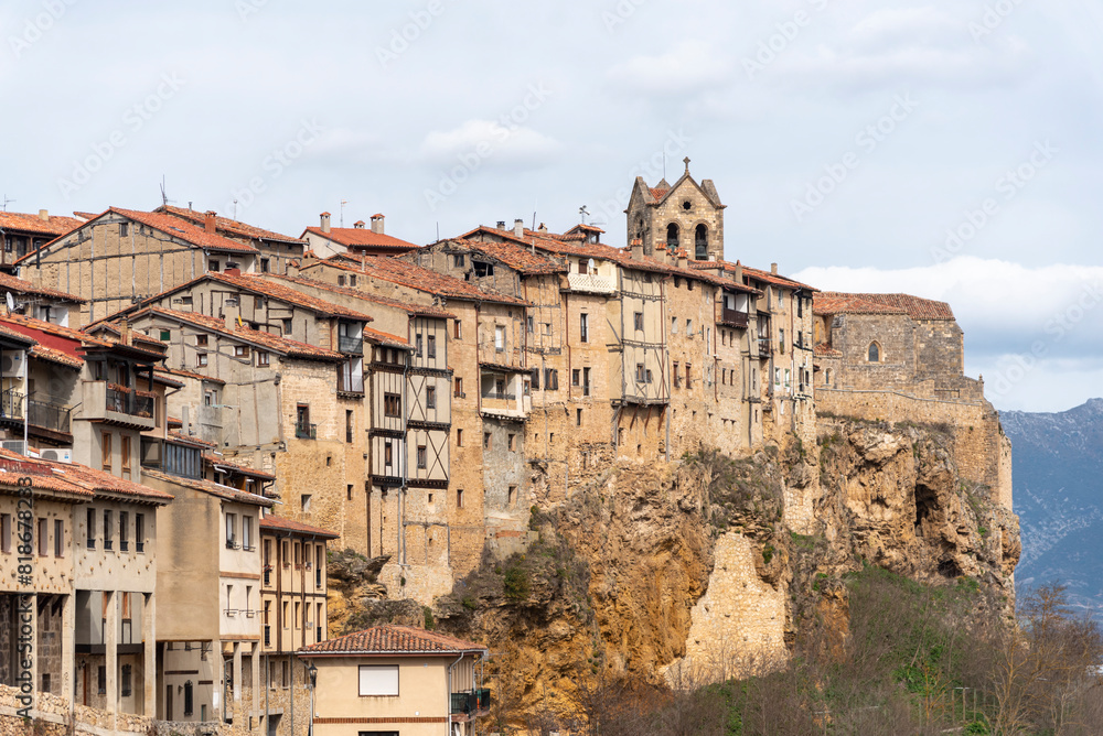 Panoramic view of the beautiful and touristic village of Frías in the province of Burgos, full of small houses of brick, wood and stone and in the background an impressive medieval church