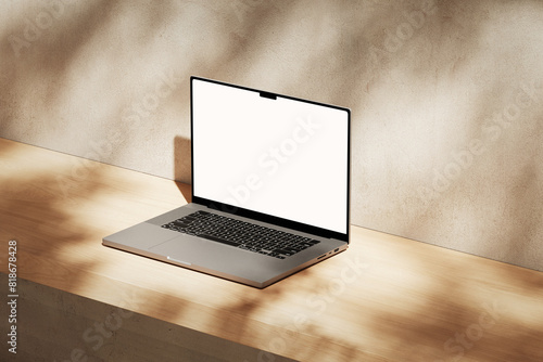 Apple MacBook Pro on the wooden desk on a plaster background
