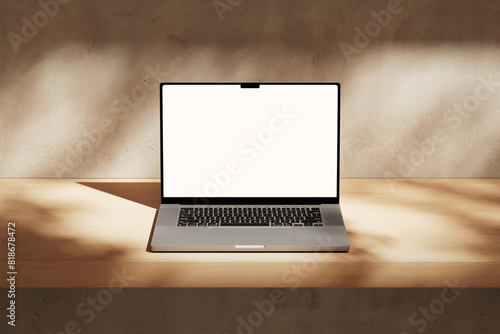Apple MacBook Pro on the wooden desk on a plaster background