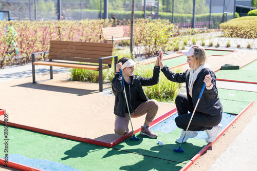 Family Time Playing Mini-Golf In The Summer photo