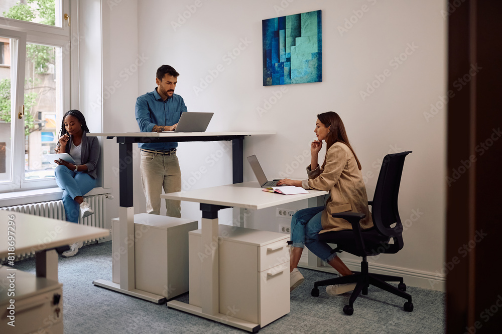Group of young entrepreneurs working at creative office space. Group of young entrepreneurs working at creative office space.