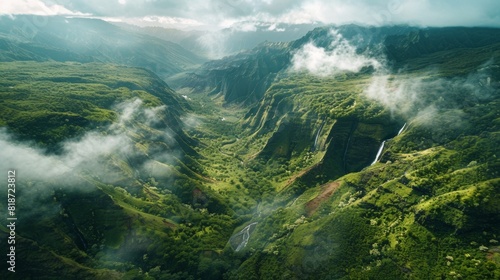 An aerial shot of a remote  mountainous region with winding hiking trails and cascading waterfalls  featuring an empty space suitable for showcasing eco-conscious travel experiences