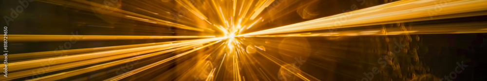 Obraz premium Abstract Golden Light Burst with Dynamic Energy Rays in Dark Background