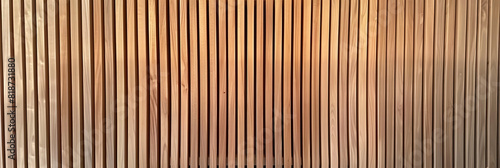 Wooden wall background with vertical slats  texture of natural wood paneling for interior design or backdrop. Wooden paneling wall. 