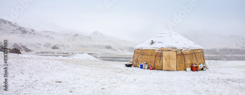 Yurts in winter. National ancient house of the peoples of Kyrgyzstan and Asian countries. national housing. Yurts against the backdrop of snow and highlands. Yurt camp for tourists. photo