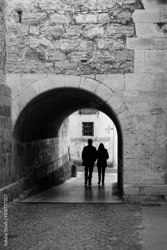 Couple walks through a passageway in the historic center of the village of Moia (Spain) photo