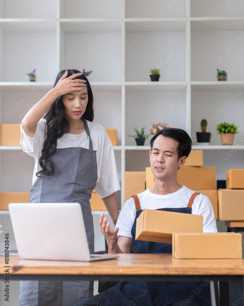 A business couple selling online products is stressed over a problem with a faulty order processing system that has not yet been resolve. A business couple selling online products is stressed over a problem with a faulty order processing system that has not yet been resolve.