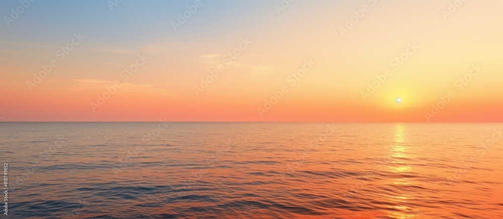 Fototapeta premium A tranquil evening seascape with an orange sea horizon offering a serene and peaceful sea view Perfect as a copy space image