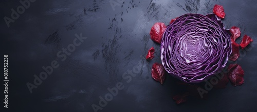 A top down view of red cabbage placed on a grey table with ample copy space available photo