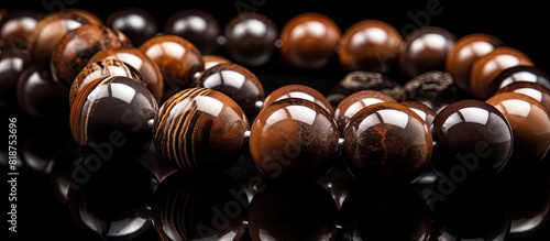 A captivating copy space image featuring brown jasper beads beautifully showcased against a black backdrop photo