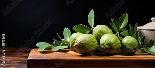 Copy space image of ripe feijoa fruit and leaves placed on a wooden chopping board photo