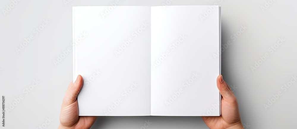 A5 open book mockup held by hands showcasing a blank page for design isolated on a white background providing copy space image
