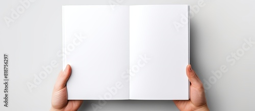 Obraz na płótnie A5 open book mockup held by hands showcasing a blank page for design isolated on a white background providing copy space image w salonie