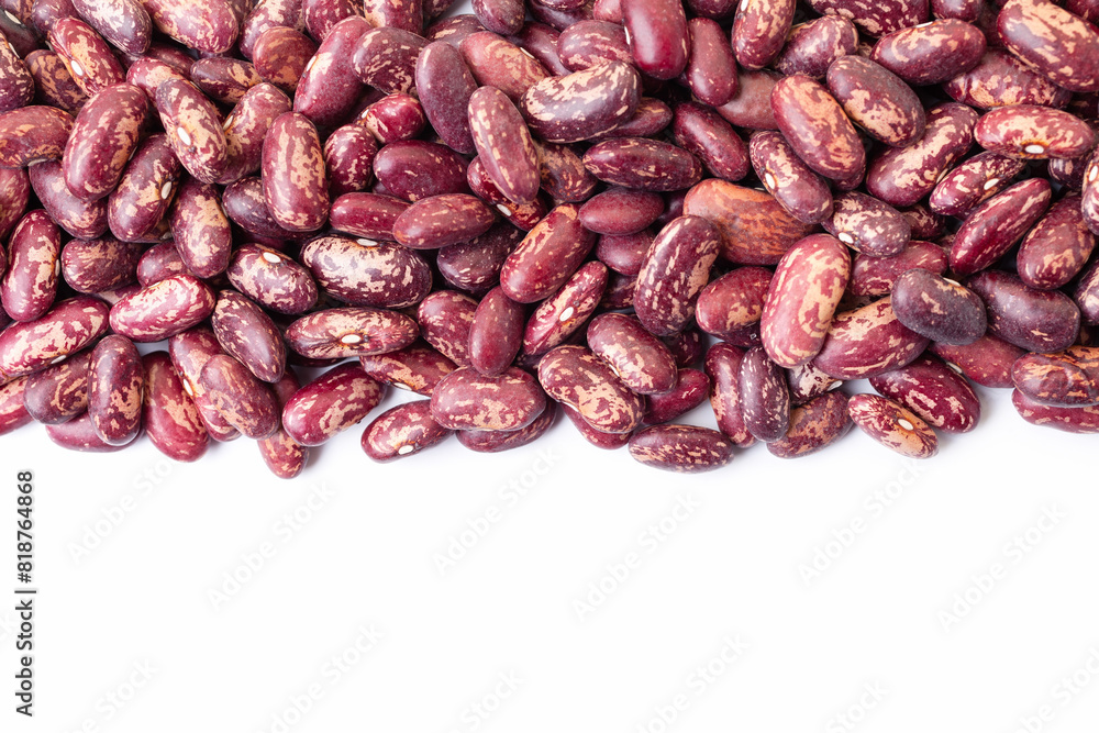 Uncooked, variegated kidney bean seeds border on white background. Copy space for text. Top view Uncooked, variegated kidney bean seeds border on white background. Copy space for text. Top view