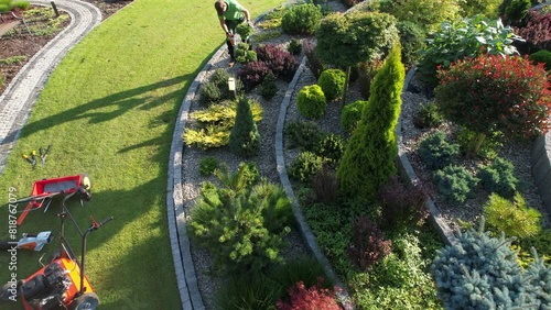 Gardener Performing Backyard Rockery Garden Maintenance