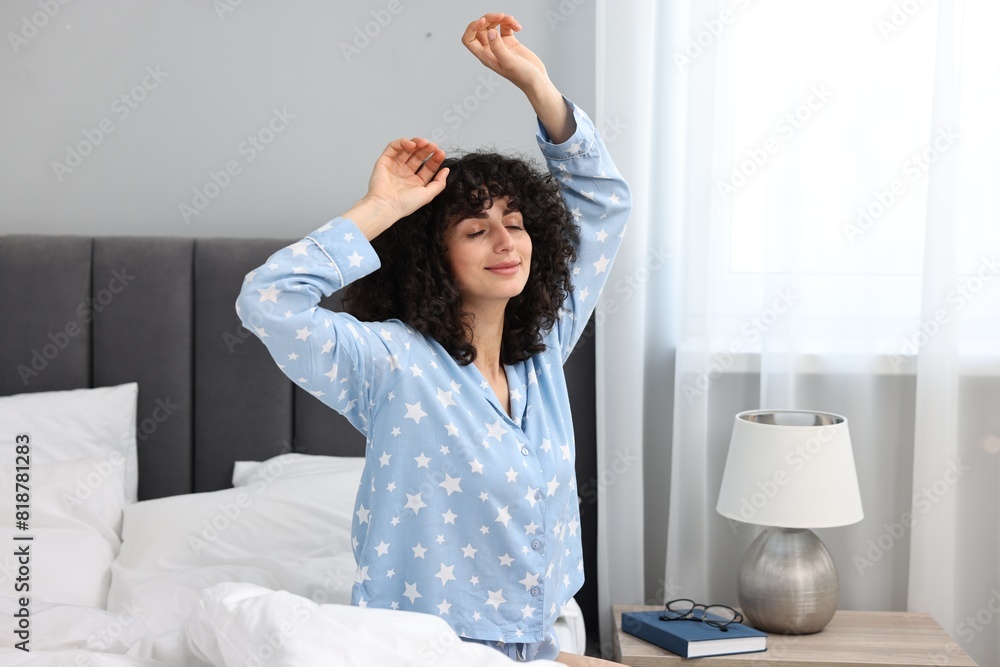 Beautiful young woman in stylish pyjama on bed at home Beautiful young woman in stylish pyjama on bed at home