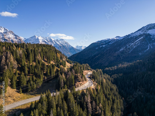 Εκτύπωση καμβά the mountains surrounding a road in the foreground, snow capped peaks behind the