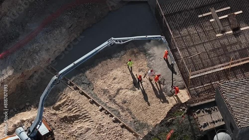 Drone hyper laps of a pouring of concrete in a construction site on a sunny day
