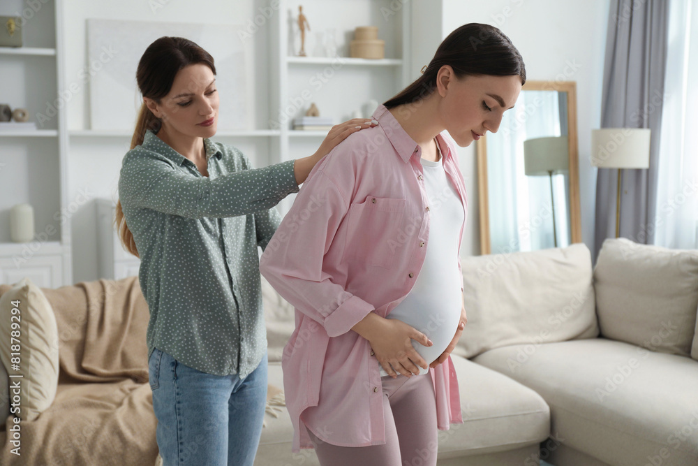 Doula massaging pregnant woman at home. Preparation for child birth Doula massaging pregnant woman at home. Preparation for child birth