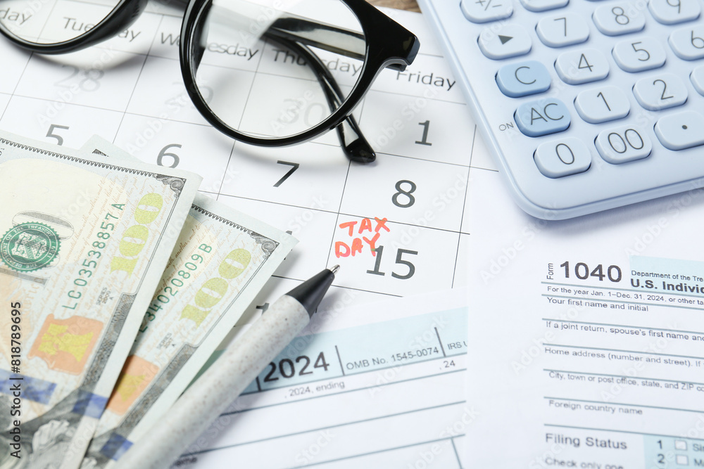 Calendar with date reminder about tax day, documents, money, pen, glasses and calculator, closeup Calendar with date reminder about tax day, documents, money, pen, glasses and calculator, closeup