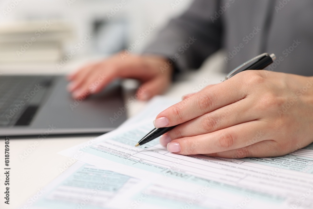 Secretary doing paperwork at table in office, closeup Secretary doing paperwork at table in office, closeup