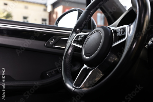 Steering wheel inside modern black car, closeup view © New Africa
