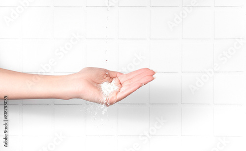human hands with enzyme powder and splashes of water on them
