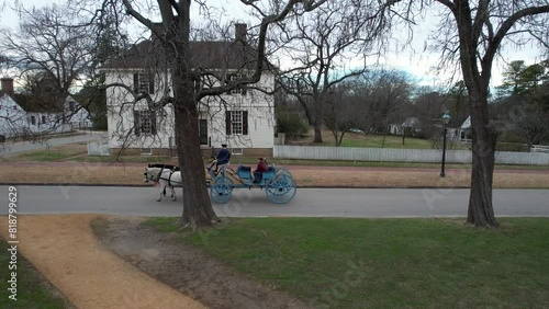 Drone footage of a blue carriage driving on the Palace Green street in Williamsburg, Virginia, USA