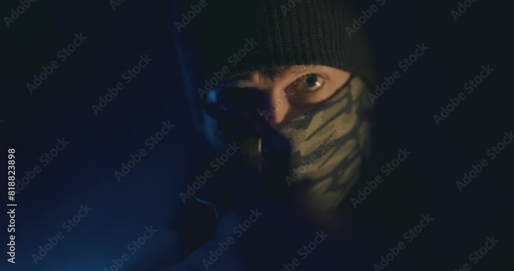 Masked gunman wielding a rifle Masked gunman wielding a rifle