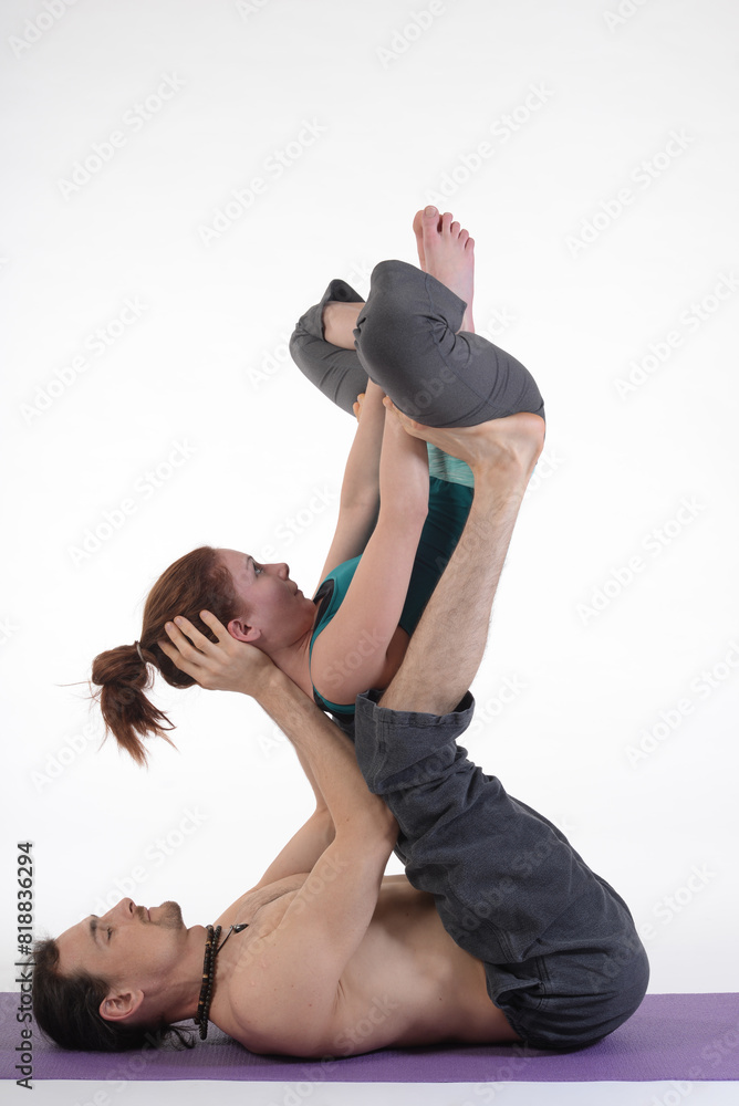 Fototapeta premium People practicing acro yoga in photo studio. Acro yoga sport theme concept.