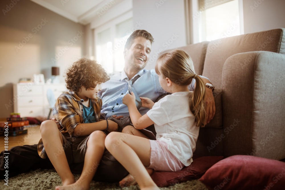 Happy father playing with son and daughter at home Happy father playing with son and daughter at home