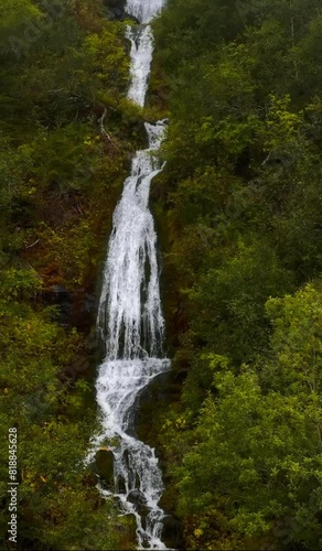 Drone vertical slow-motion of natural waterfall in a hidden forest in Trysil, Norway photo