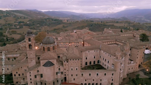 Ascending drone shot of Ducal Palace of Urbino and Cathedral of Santa Maria Assunta, Italy