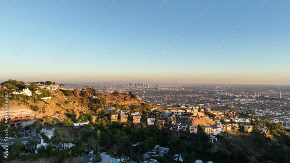 Drone above luxurious residencies built in slope surrounded with green vegetation in Los Angeles Drone above luxurious residencies built in slope surrounded with green vegetation in Los Angeles